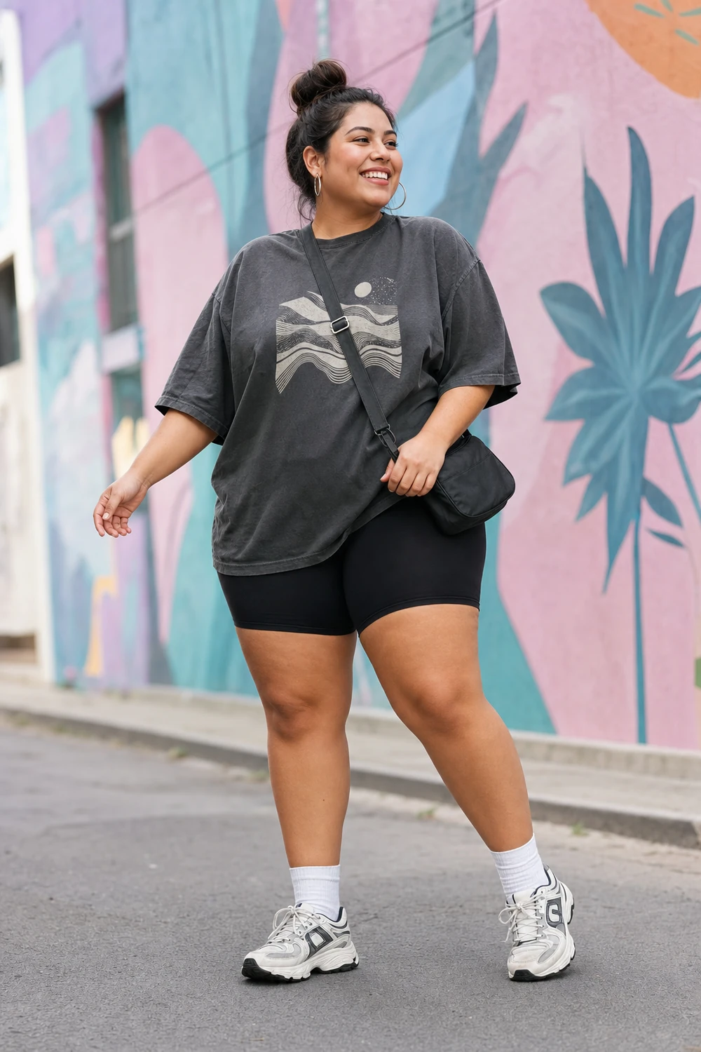 Plus size woman styling an oversized graphic T-shirt with black biker shorts