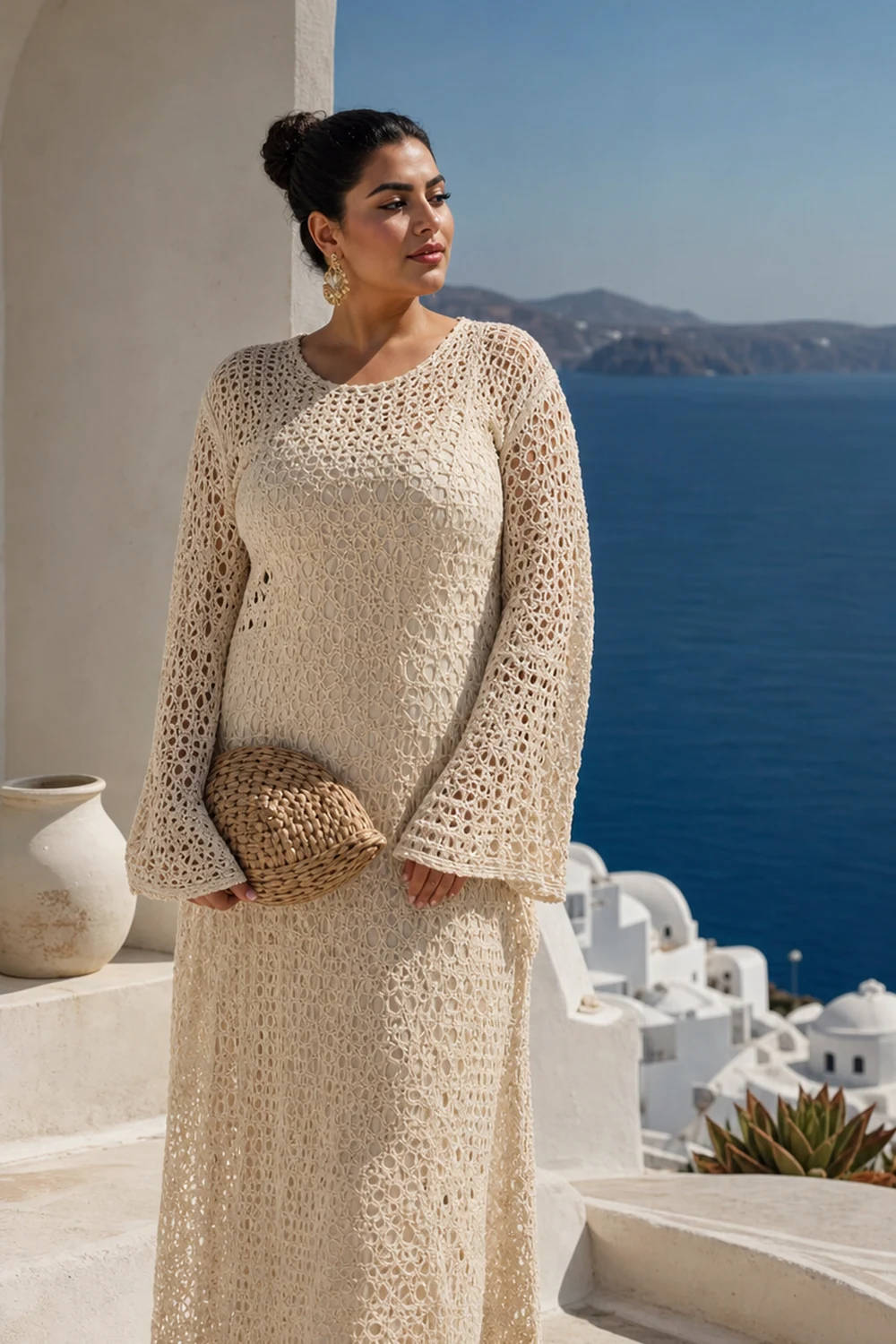 Curvy woman wearing a cream crochet maxi cover-up over a tonal swimsuit