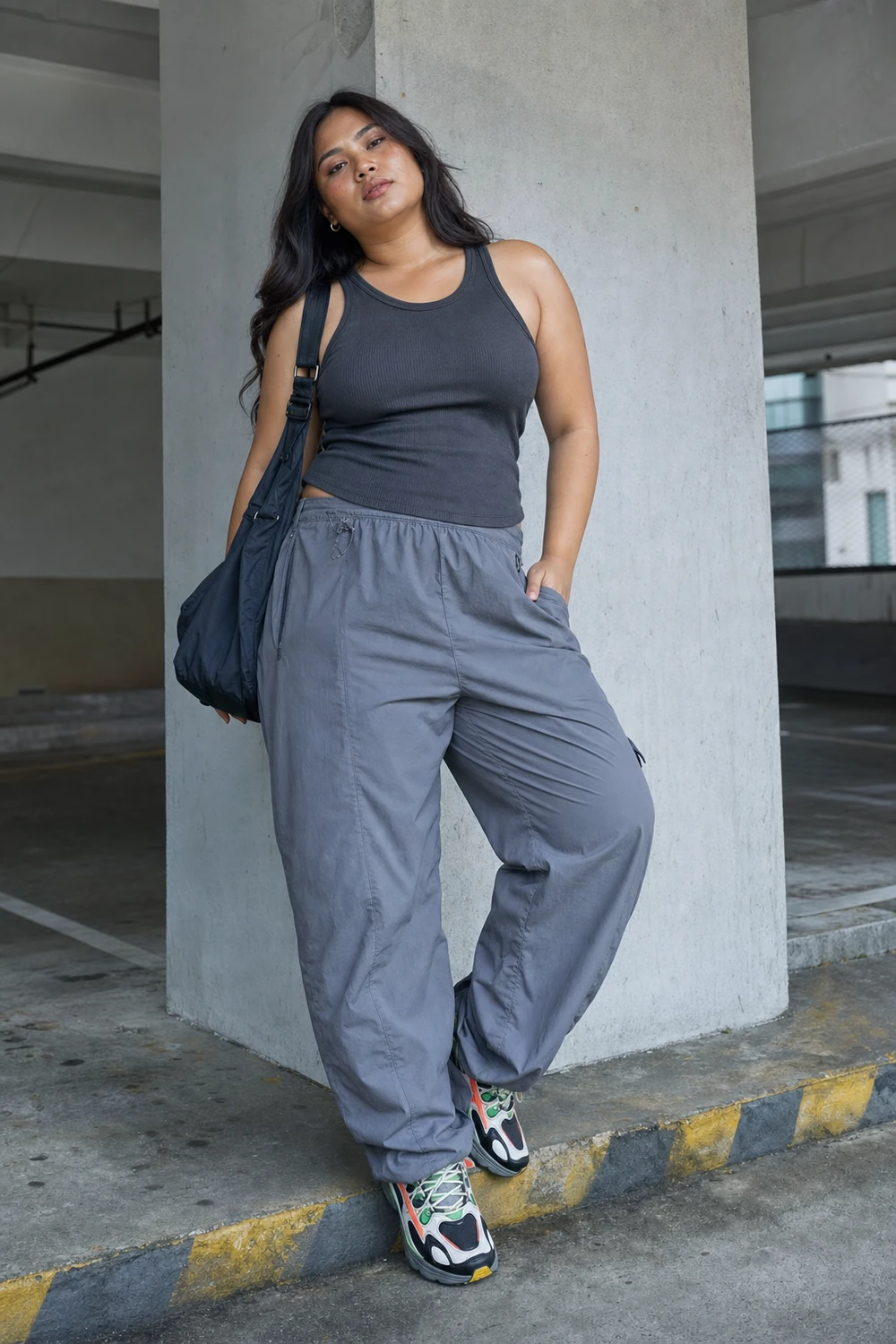 Plus size woman wearing parachute pants with a fitted tank top