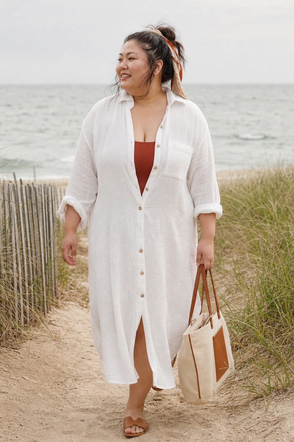 Plus size woman wearing a white cotton gauze shirt dress with beach slides