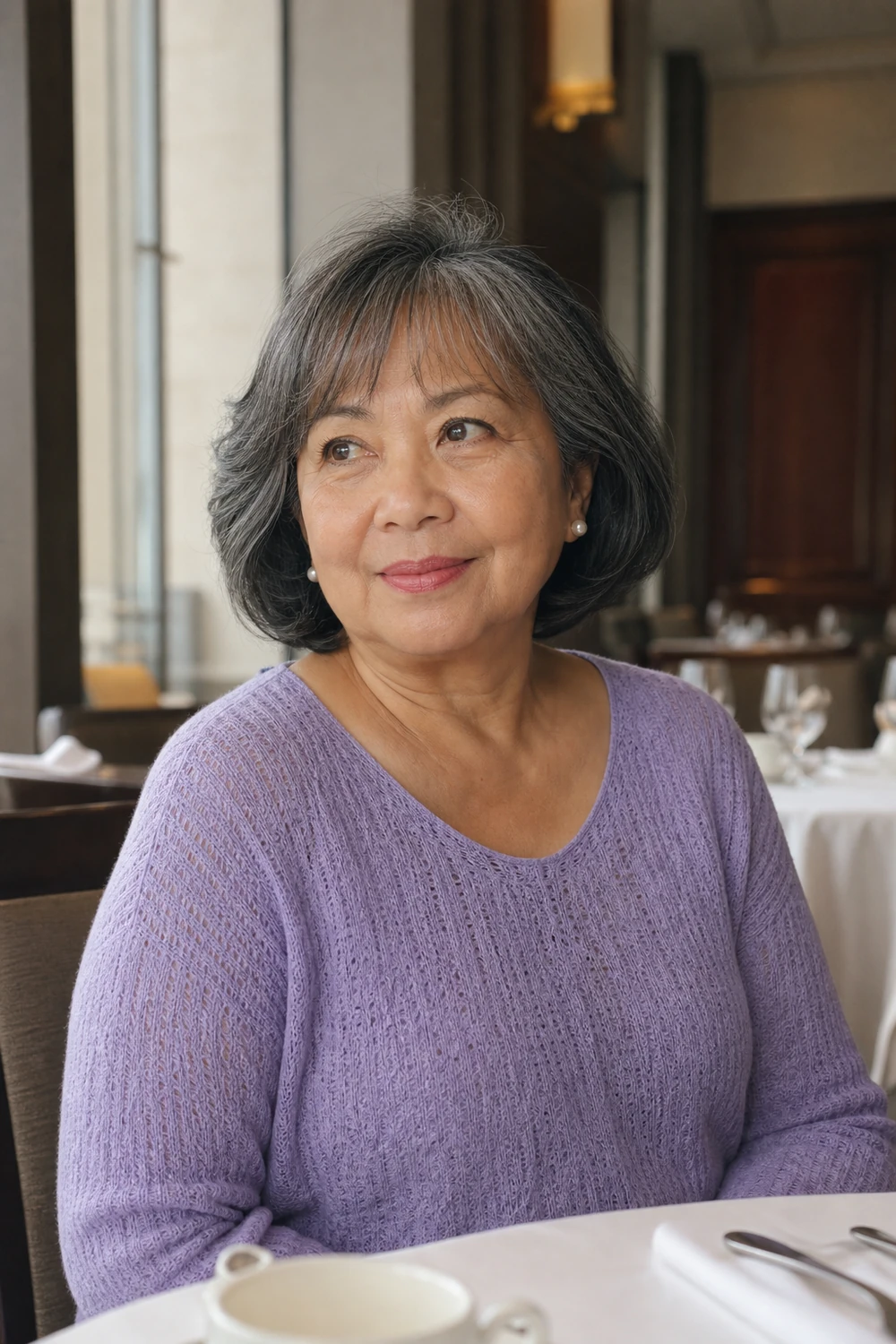 Older plus size woman with a softly rounded bob and wispy fringe