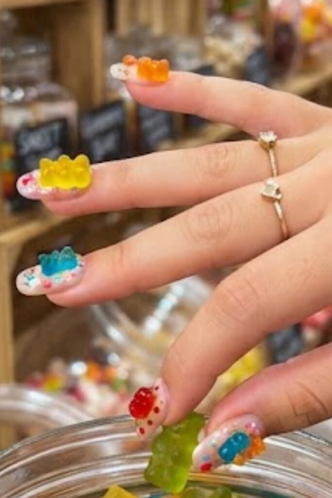 Candy shop scene nail art with painted gummy bear jars