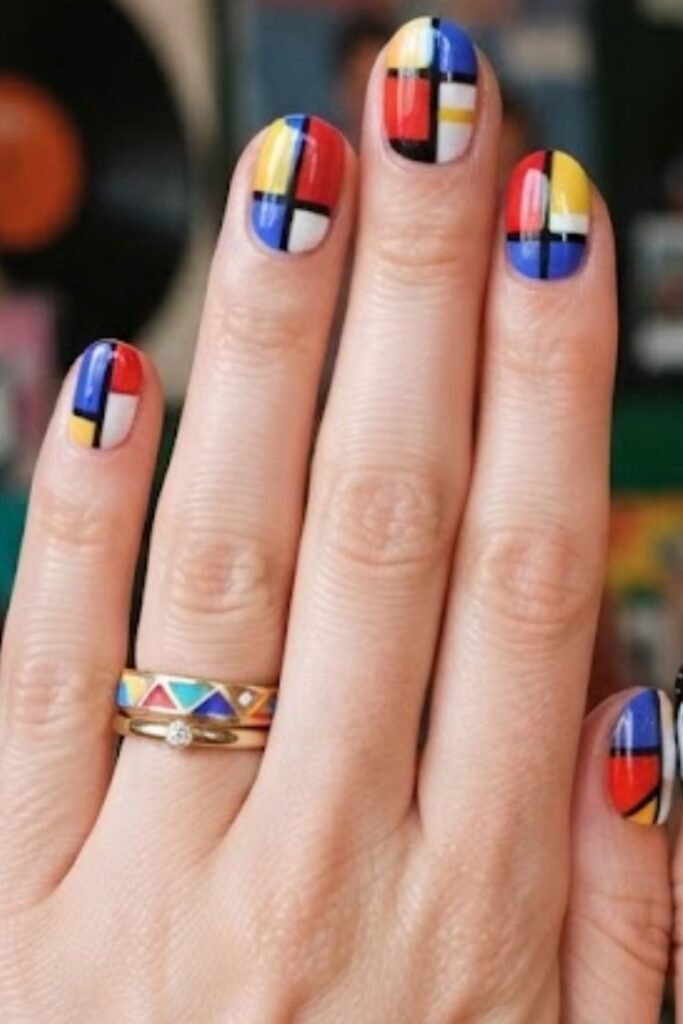 Color block manicure in primary red, yellow and blue with black and white