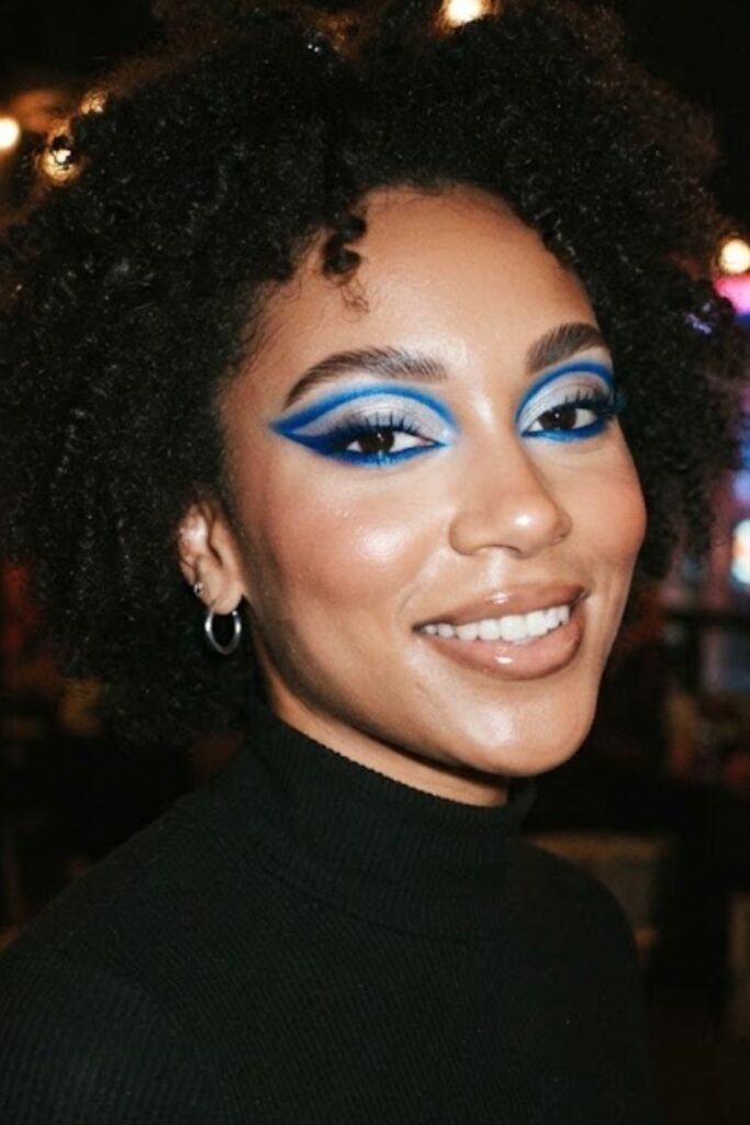 Woman wearing an electric blue cut crease eyeshadow look