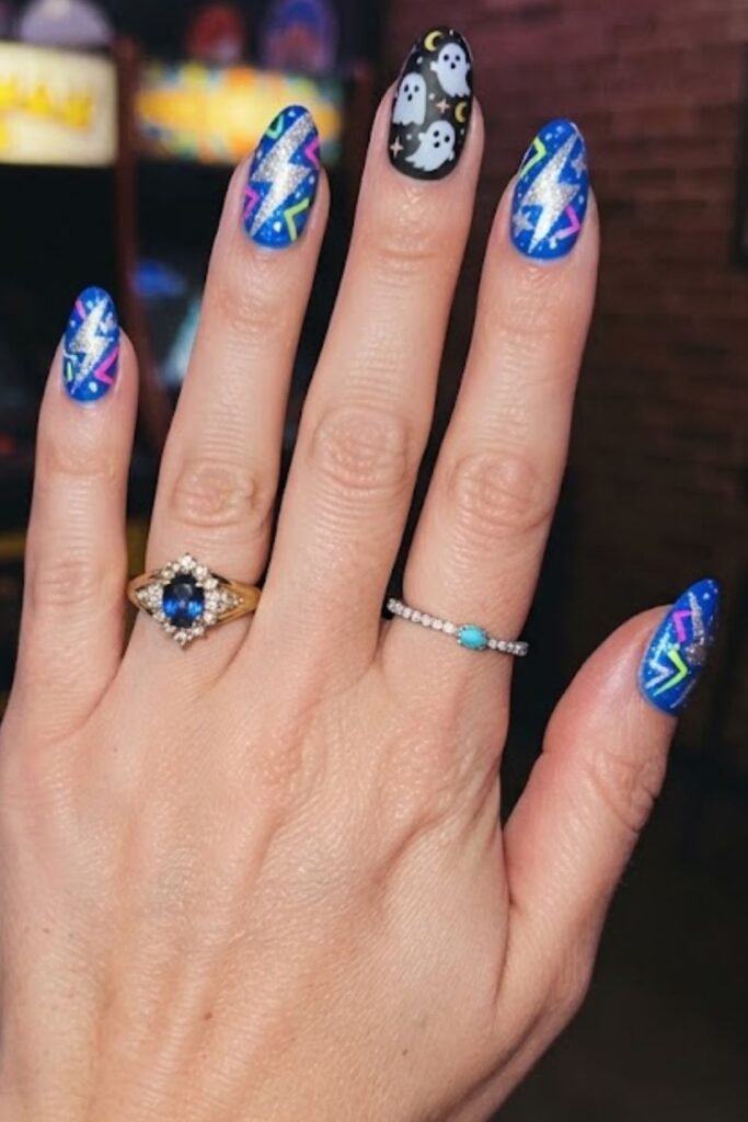 Electric blue nails with a silver lightning bolt design