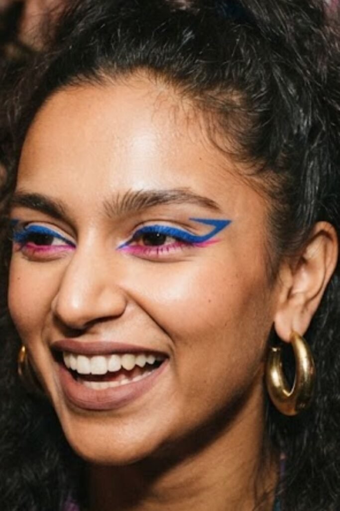 Woman with bold graphic colored eyeliner in an 80s style