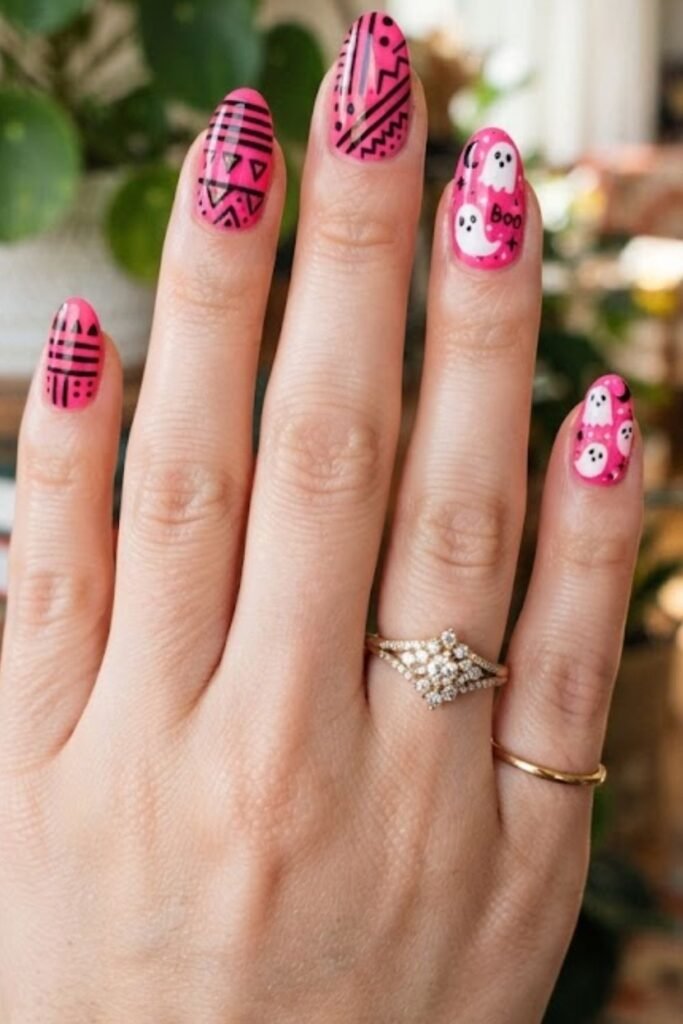 Hot pink nails with bold black geometric shapes
