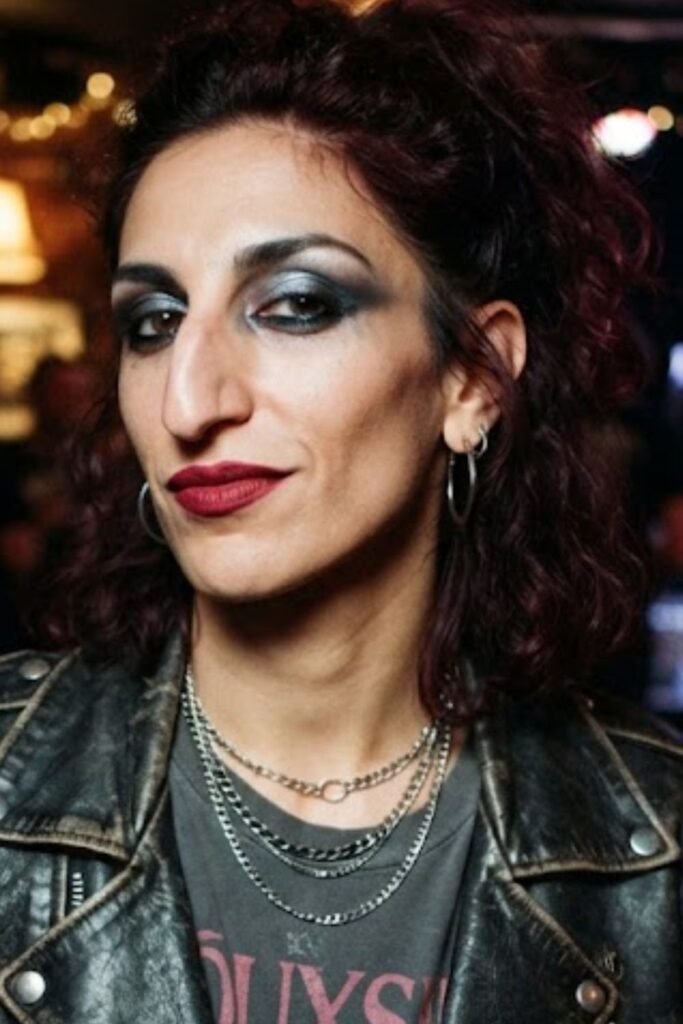 Woman with a rock chic smudged kohl eye and oxblood lip