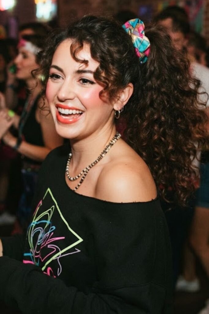 Woman with a high 80s side ponytail and scrunchie