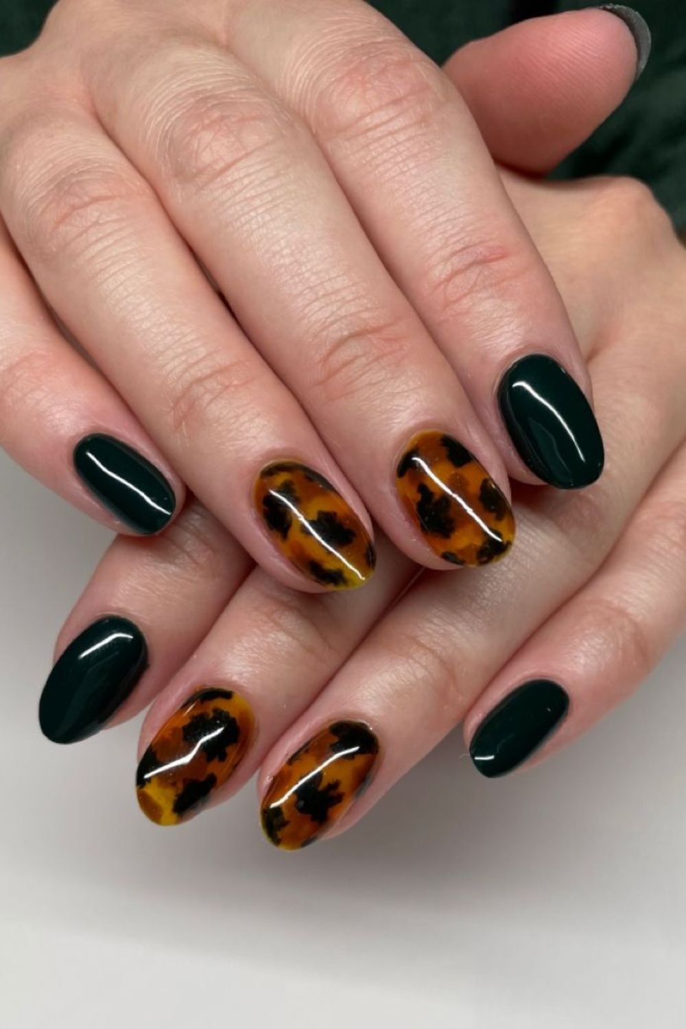 Forest green nails with amber tortoiseshell accent nails