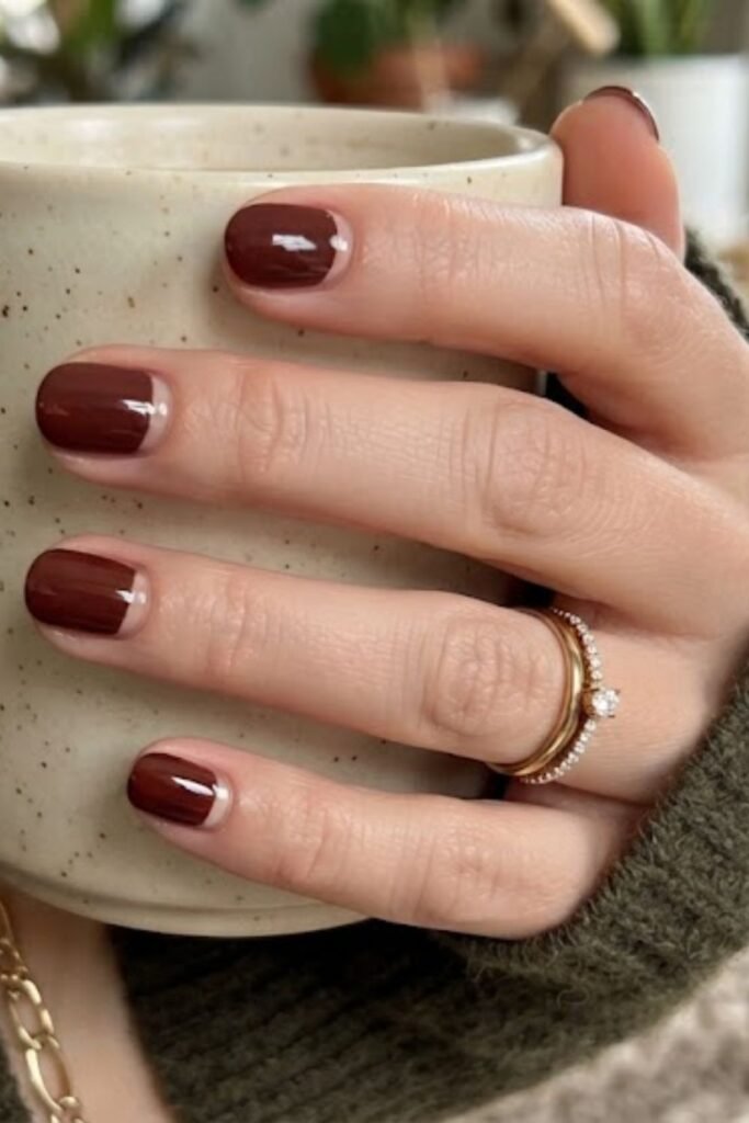 Cherry mocha nails with reverse French half-moons