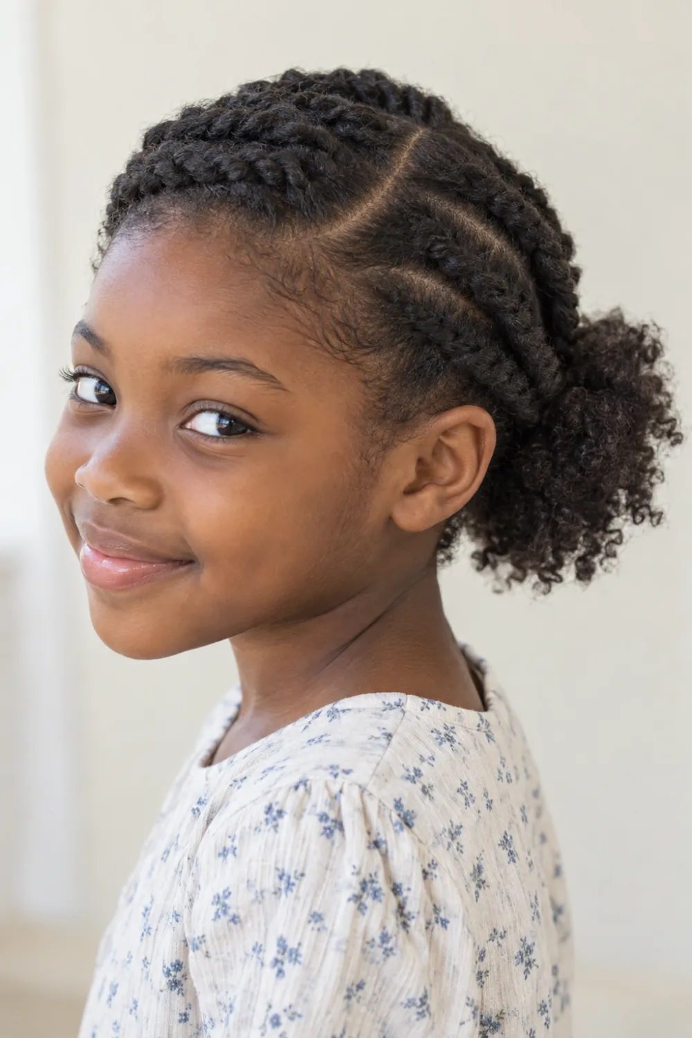 Side-parted flat twists ending in a small natural puff