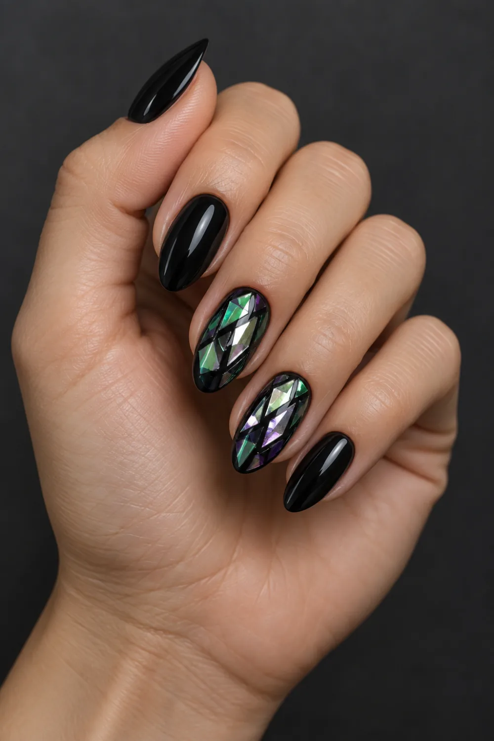 Glossy black nails with iridescent cracked-glass film accents
