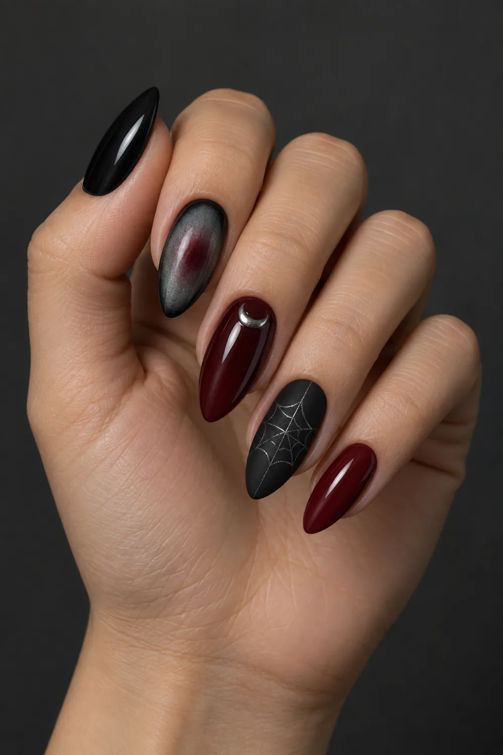 Mixed burgundy and black nails with aura, crescent and web accents
