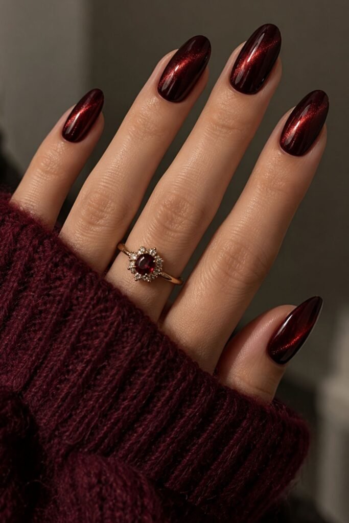 Black cherry red cat eye gel nails with a diagonal shimmer