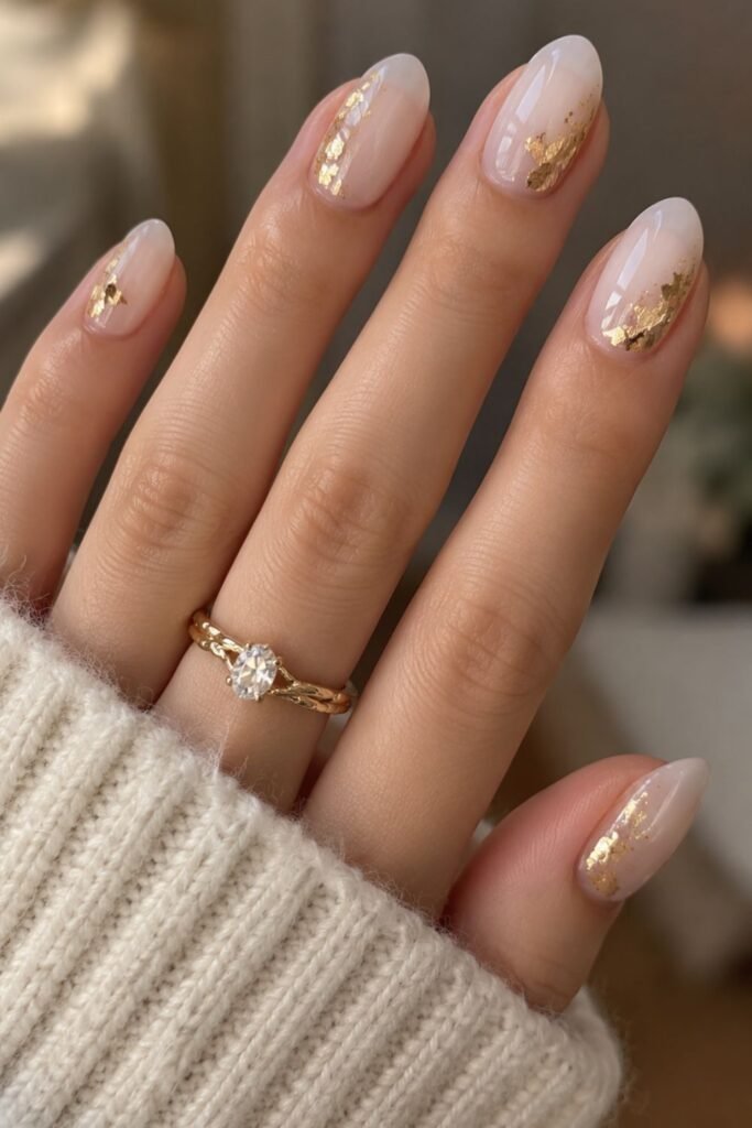 Milky white gel nails with small gold foil flakes