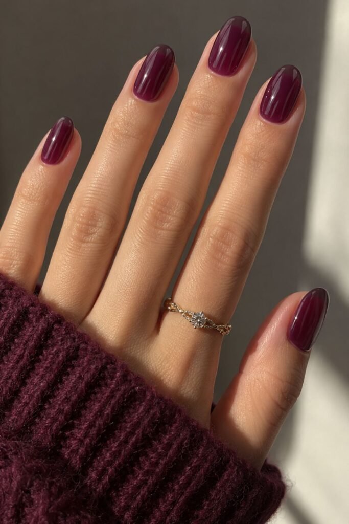 Translucent plum jelly gel nails with a glassy finish